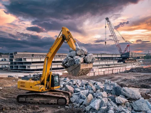 Excavator assisting bridge precast yard