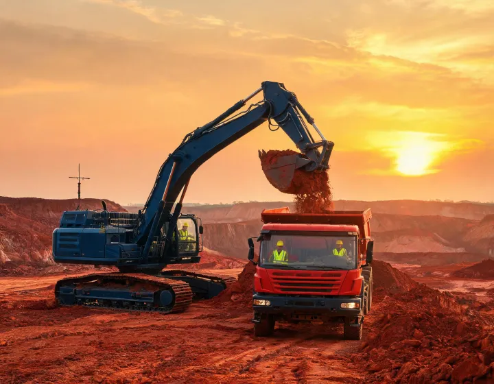 Hyundai hydraulic excavator loading articulated hauler in open cut