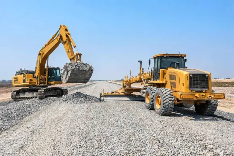 Excavator supporting base course prep
